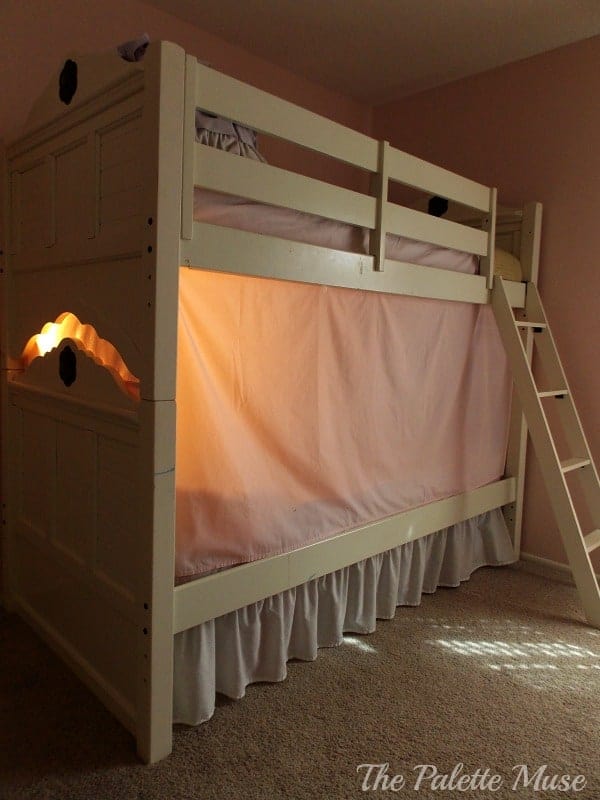 Bunk bed tent lit from the inside with a lamp