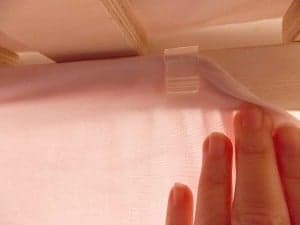 Slide the sheet and string into the command strips