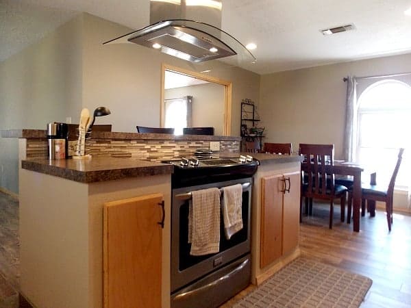 A Kitchen island with stove and range allows the cook to face the family, not the wall.