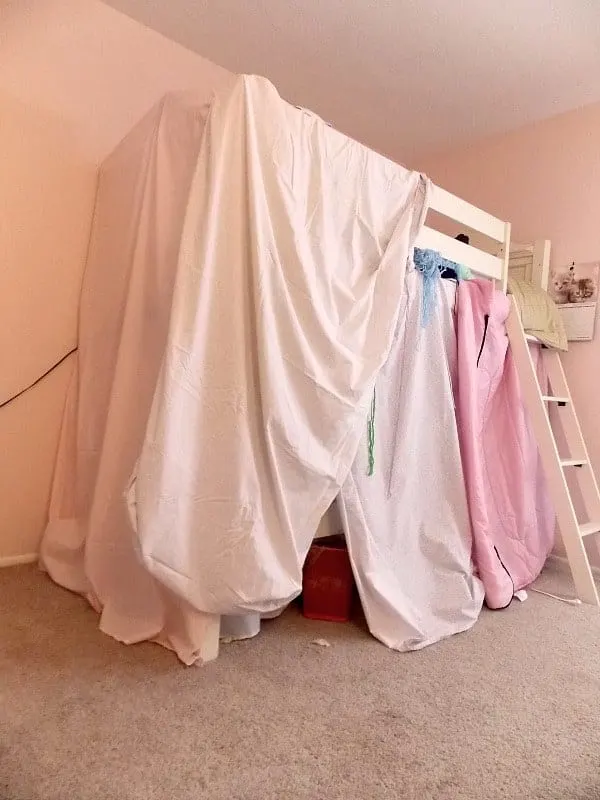 Before: bunk bed fort made out of sheets and blankets thrown over the bed