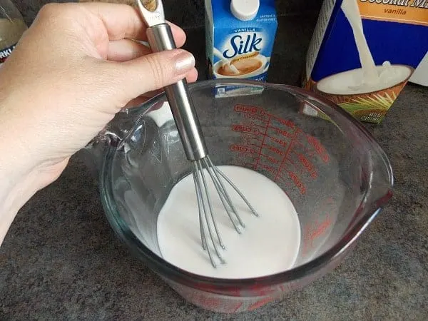 Whisking Coconut Milk and Sugar in Measuring Bowl
