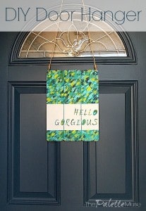 You can make this easy door hanger to welcome your guests. ThePaletteMuse.com