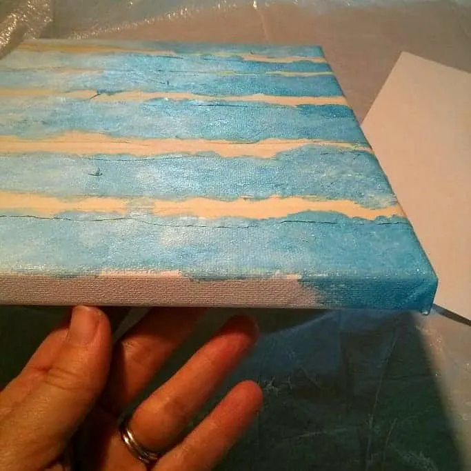 Painting edges of the canvas with blue sky color