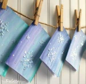 Snowflake greeting cards hanging to dry on a line