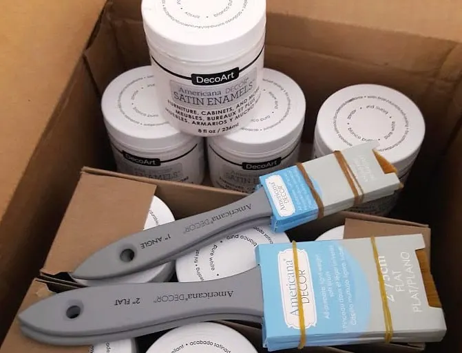 Box of paint and paintbrushes from DecoArt