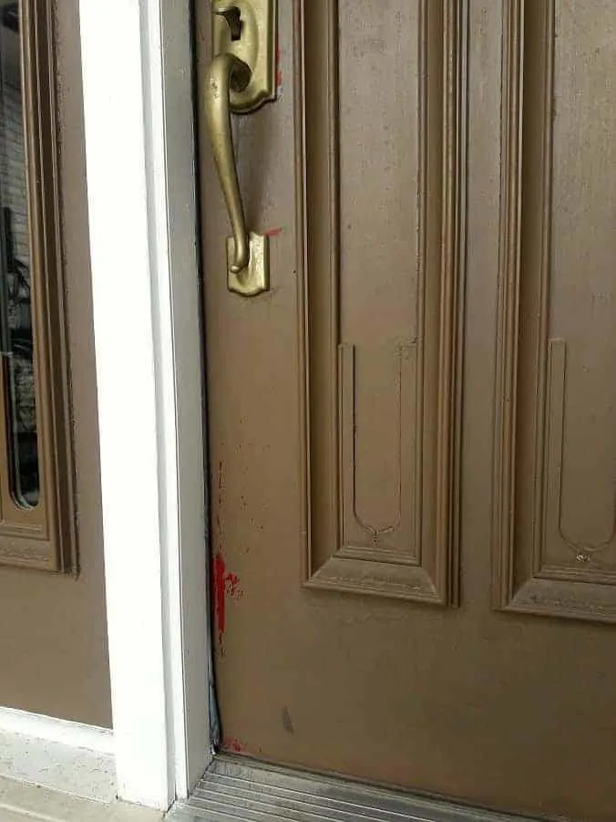 Old door handle with chipped paint.