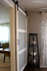 White barn door header matches the white trim throughout the room