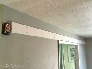 Hanging Barn Doors - attach your laser level to the wall and leave it there while you're installing the header and rail.