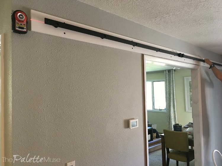 Hanging the bar for double barn doors, using a laser level