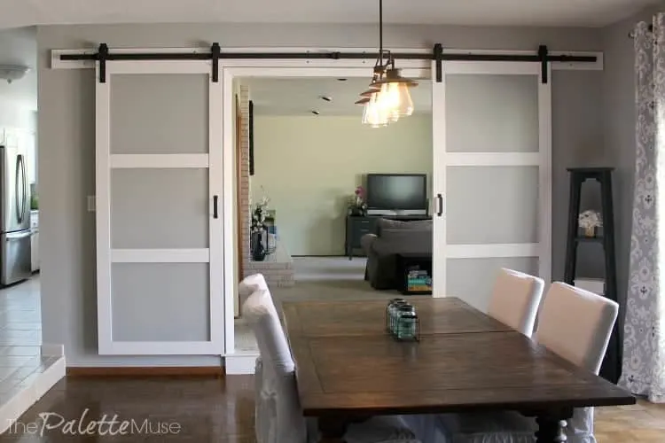 White and frosted glass double barn doors in the dining room