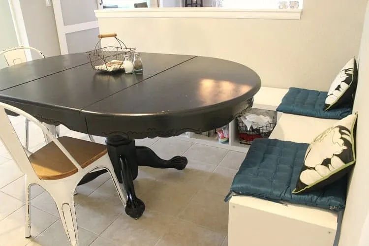 black dining table with white bench seating