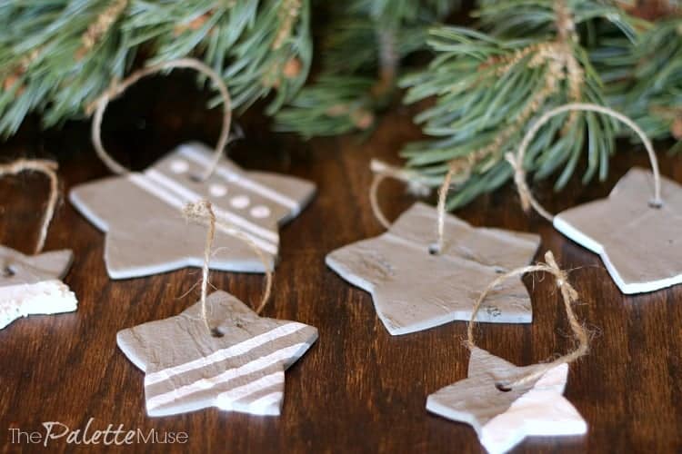 Concrete star ornaments painted with white accents, ready to hang on the tree