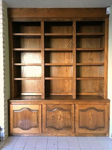 Dark brown built in bookshelves with cabinets on the bottom section