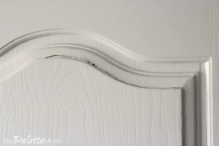 Slight bubbling of paint on the top edge of one cabinet