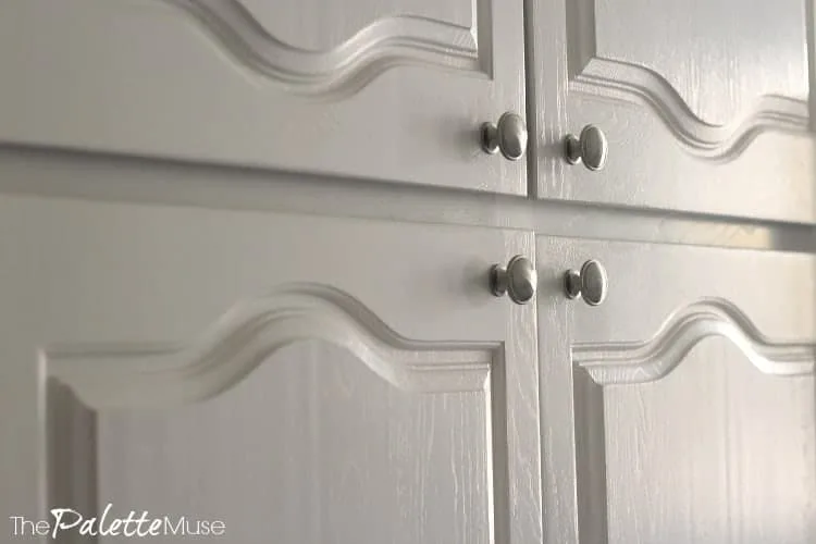 White painted kitchen cabinets detail of wood grain.