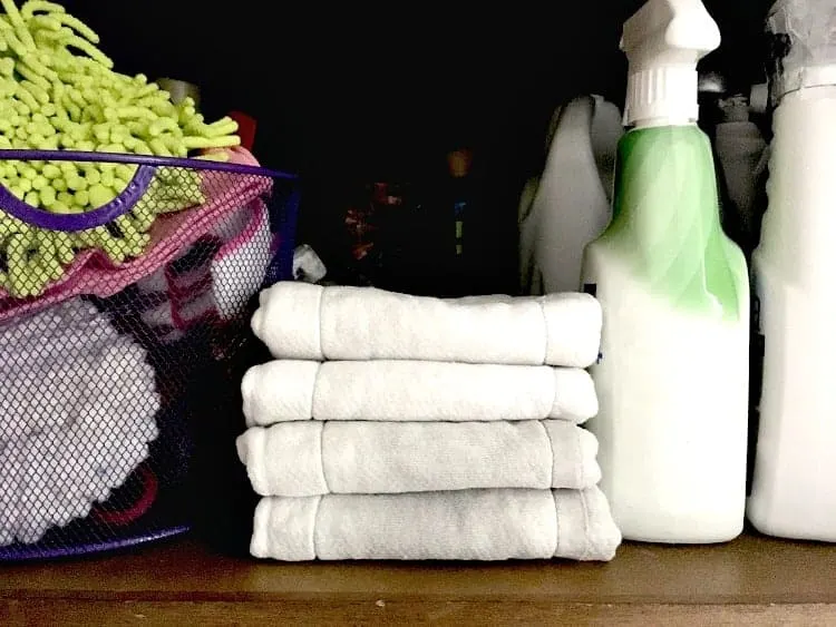Cleaning hack - stack of folder cloth diapers on cleaning closet shelf
