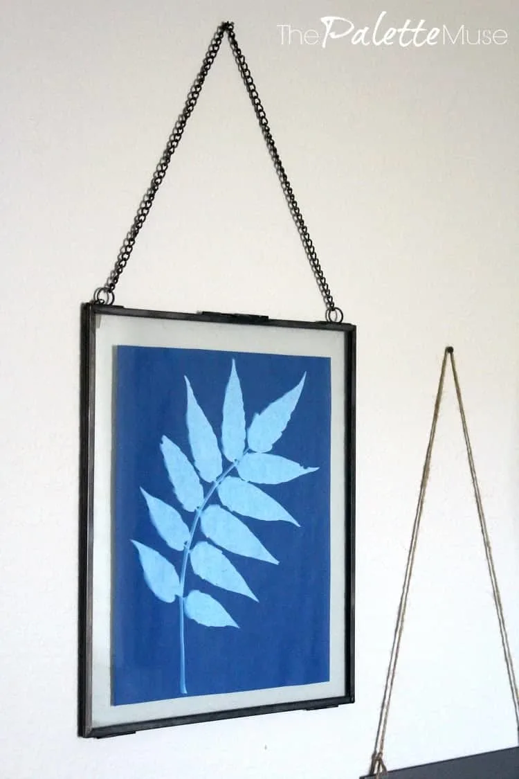 Solar print framed in metal and glass hanging from for the home office makeover.