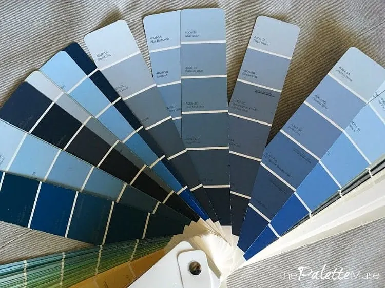 Blue paint colors displayed for picking an accent wall color in the office.