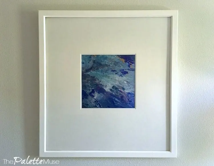 Closeup shot of blue poured acrylic painting in white frame