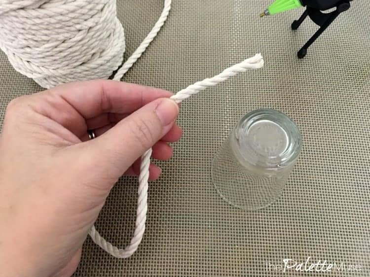 Holding the end of a rope, ready to glue it onto a shot glass