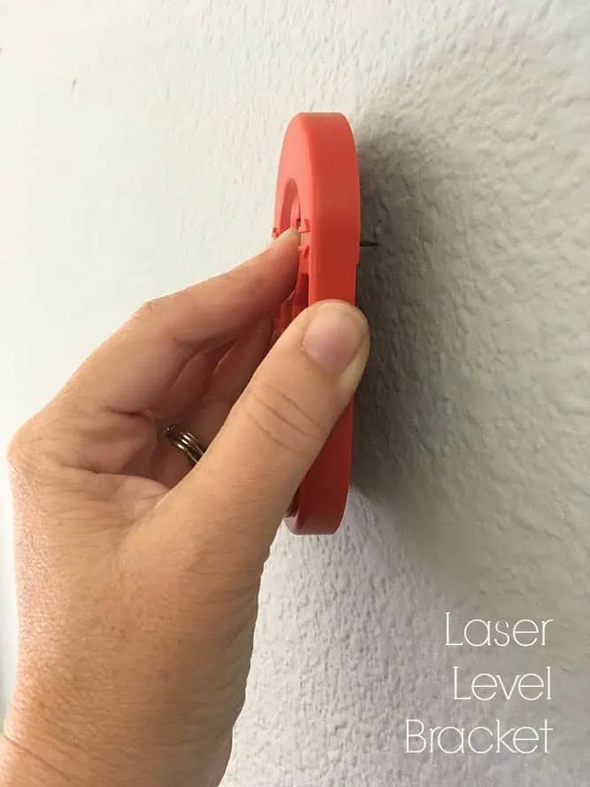 tacking the laser level bracket to the wall
