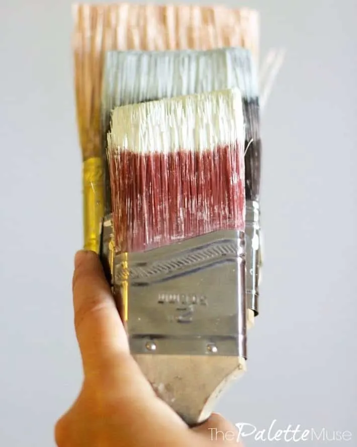 Multiple paint brushes with different colors of paint