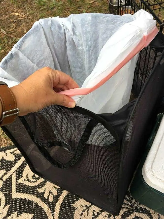 Camping Hacks: You can use a mesh clothes hamper to hold your trash bag.