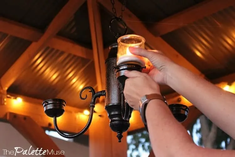 Setting a candle into a hanging candelabra