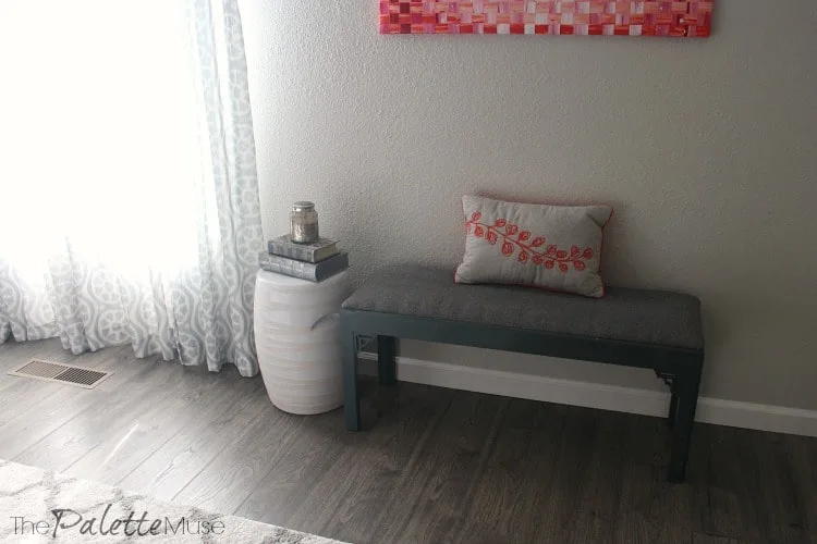 Dark gray upholstered bench and white garden stool