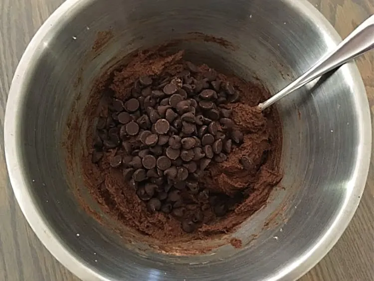Adding chocolate chips to my double dark chocolate cookie mix.