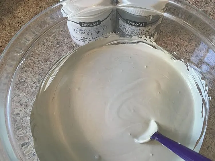 Mixing light gray paint in a glass bowl