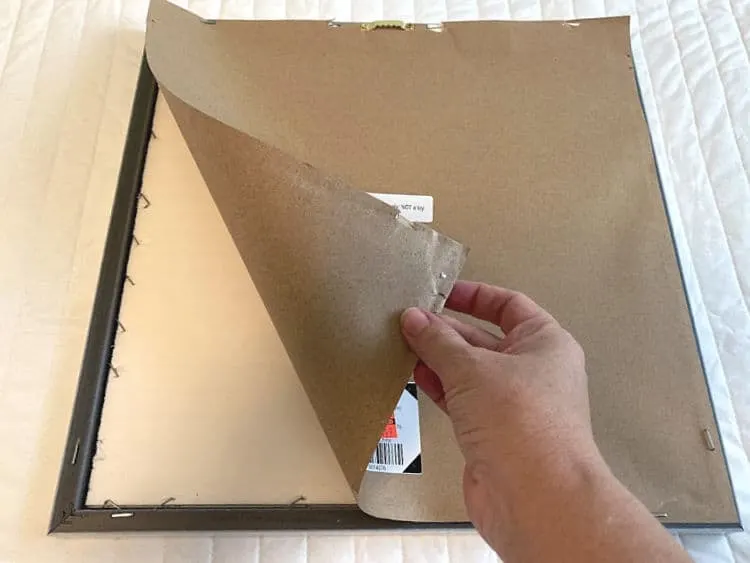Peeling the paper backing off a framed print