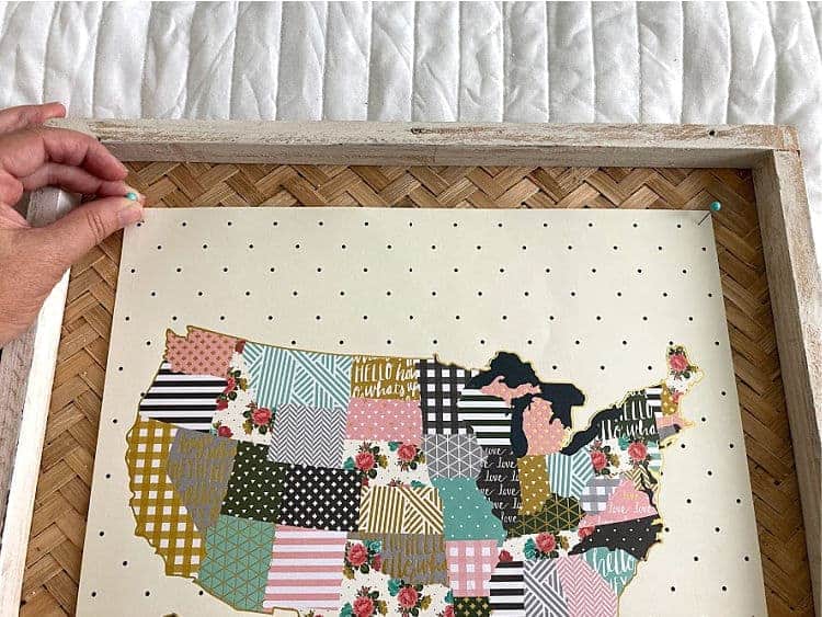 Pinning a floral map onto a frame
