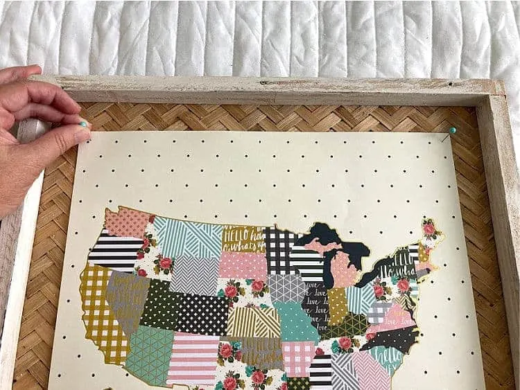Pinning a floral map onto a frame