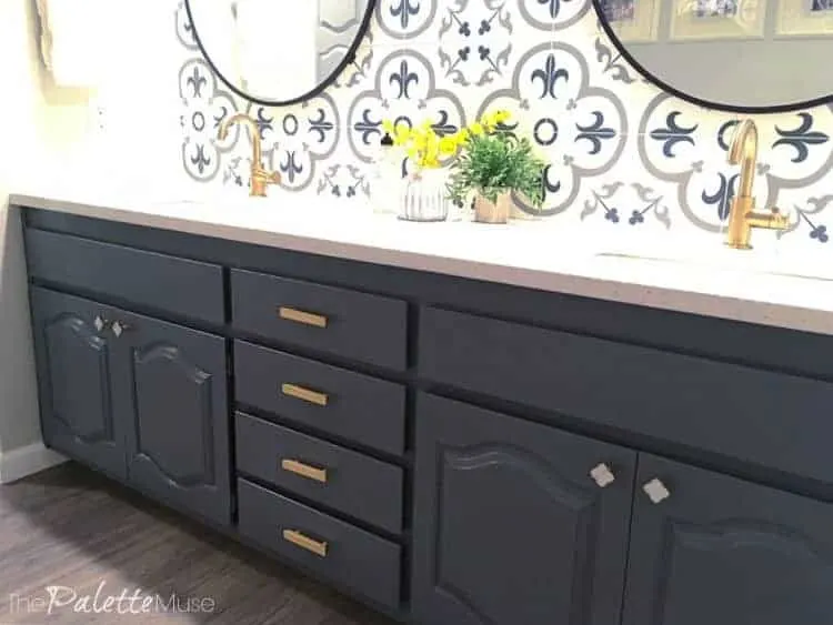 Dark gray painted cabinets in bathroom with patterned tile backsplash
