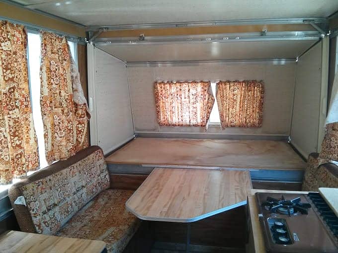 Original interior of a 1976 Apache camper with brown upholstery