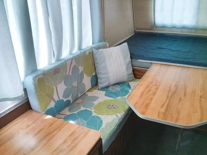 Camper dining space with blue cushions