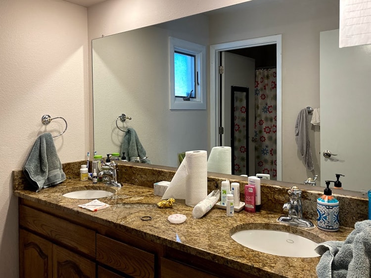 cluttered countertops and drab brown colors in girls' bathroom