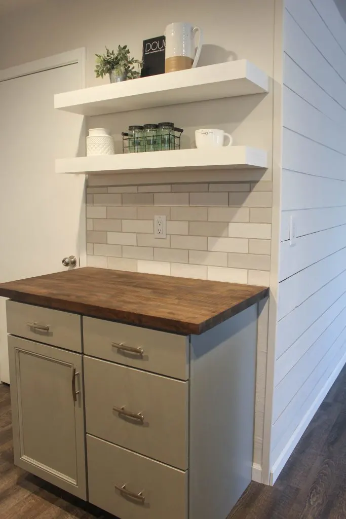 Flip House  coffee bar with gray cabinets and white shelves