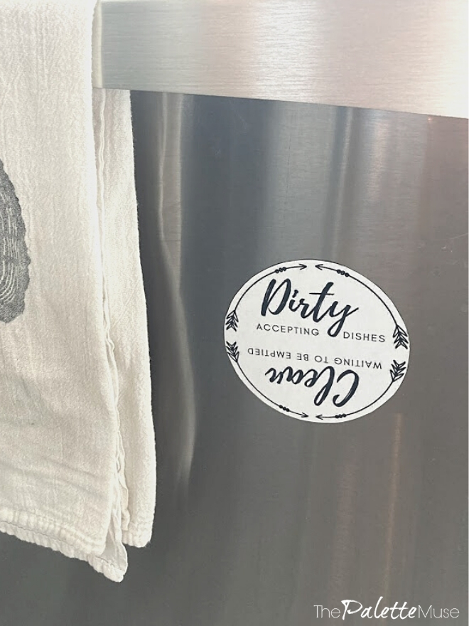A black and white dishwasher magnet that can be flipped to say clean or dirty.