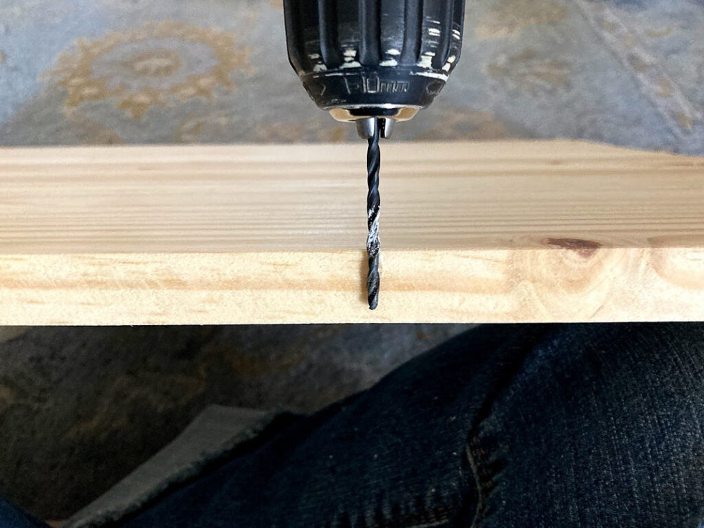 Chalk marking spot on drill bit where you should stop drilling to avoid drilling through the table top