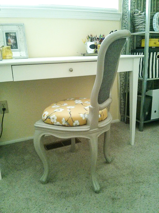 Reupholstered and repainted chair at the desk in an office decorated in yellow and gray.