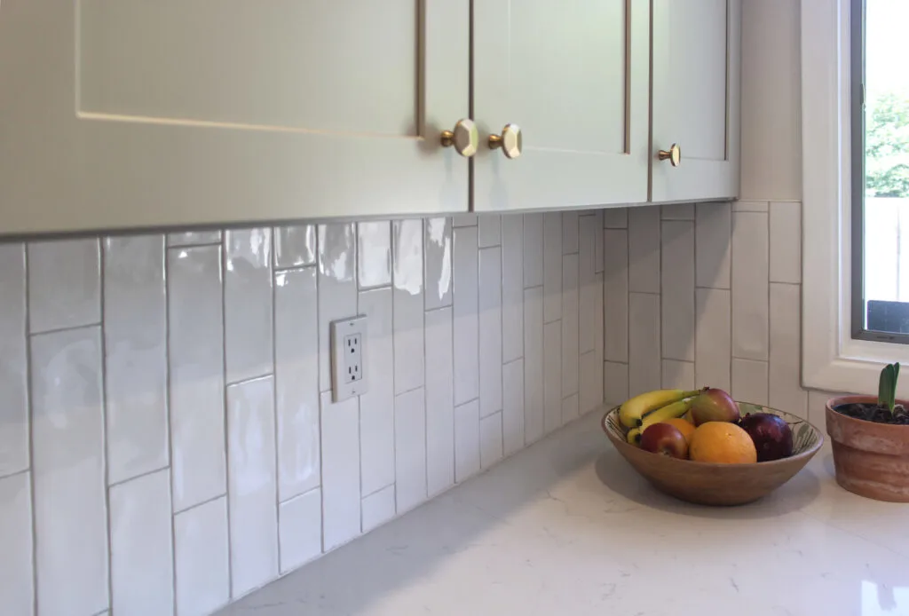 Kitchen Remodel Resources: White vertical subway tile backsplash with white quartz countertop.
