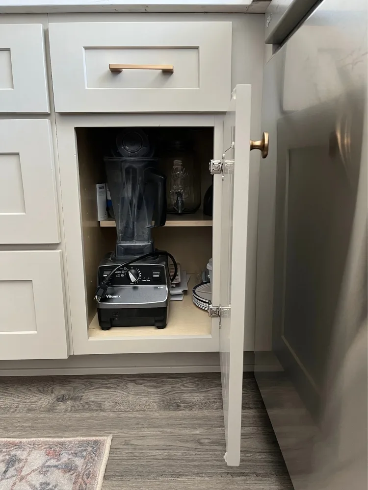 A cabinet door opening close to, but not hitting, a dishwasher.