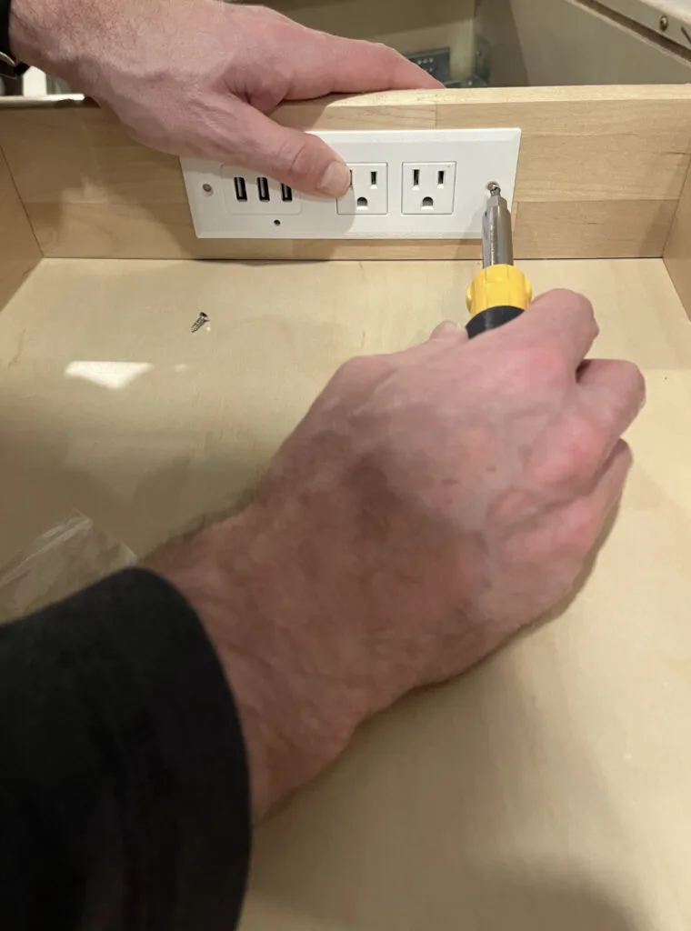 Screwing a charging strip into the back of a drawer to make a charging station.