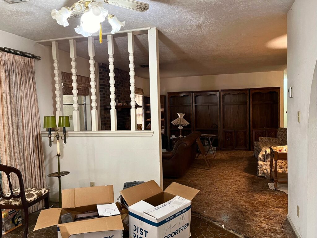 A spindle half wall interrupts the space between our flip house's kitchen and living room.