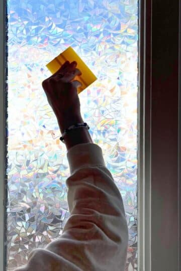 Scraping the air bubbles out after applying Privacy Film to a window.